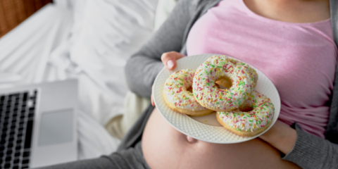 pregnnacy nutrition - pregnant woman about to eat donuts
